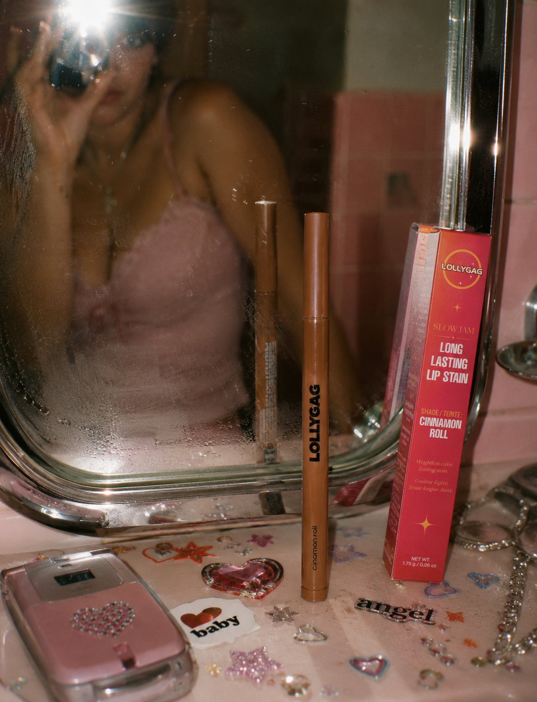 LOLLYGAG on the vanity — mirror, phone, charms